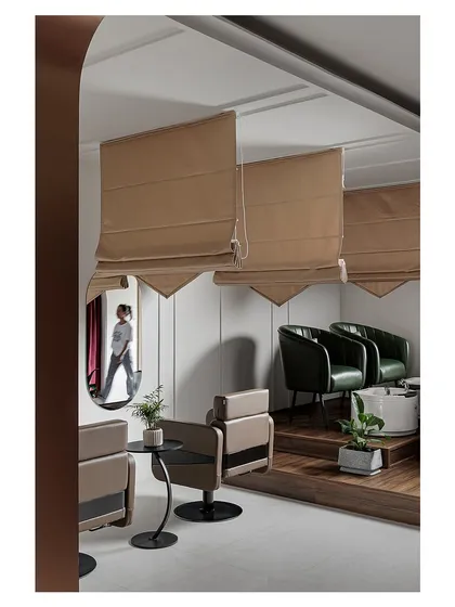 This view showcases the clever use of mirrors and varied seating arrangements to create distinct zones, like this cozy corner with deep green armchairs.