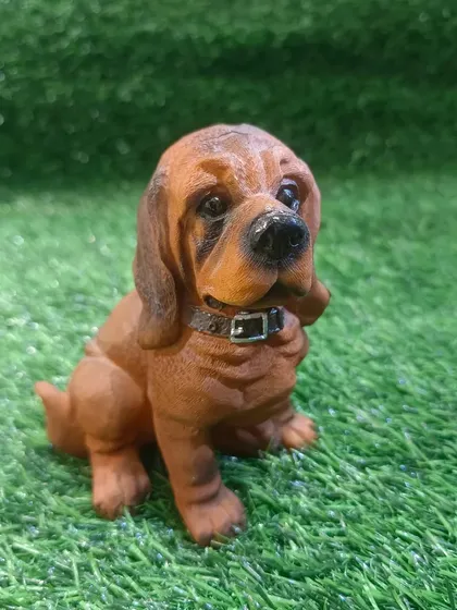 A charming Basset Hound puppy figure, crafted with realistic detail.