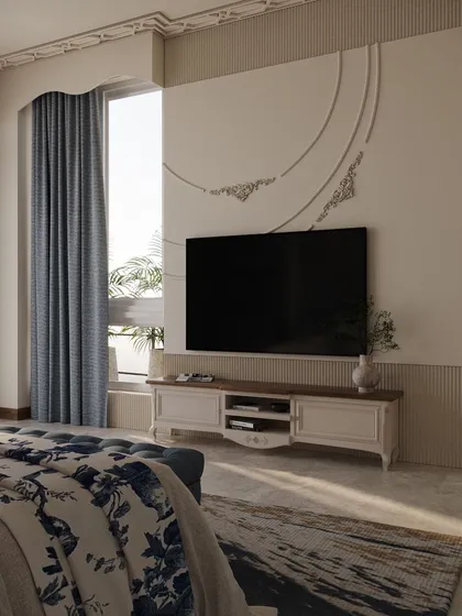 The television wall is designed with subtle classical details, including decorative moulding that forms a gentle arch, tying it into the room's overall aesthetic without being distracting.
