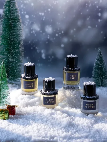 A magical, snowy Christmas scene created in our studio. We used artificial snow, miniature pine trees, and a winter-themed background to create a cozy, wonderland setting for these perfumes.