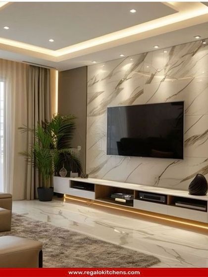 This living room features a stunning floor-to-ceiling marble media wall. The long, low-profile console provides ample storage while maintaining a sleek look.