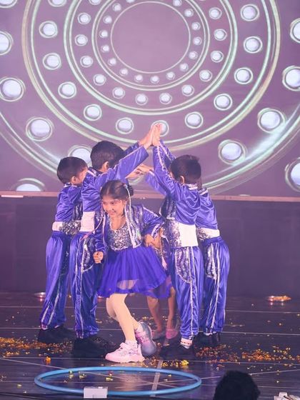 A cute formation from the "Rocky Rani" performance, where the kids dance together in a circle.