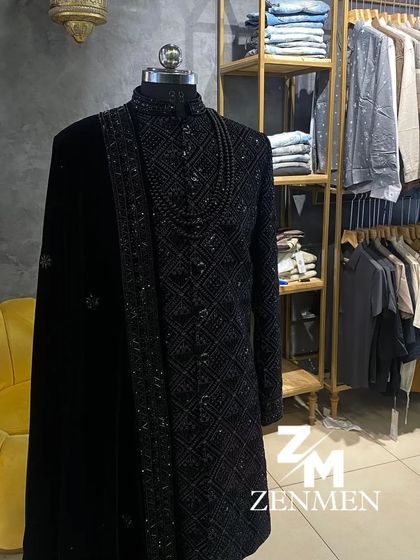 This black sherwani is designed for a lasting impression. It features intricate tonal embroidery and is paired with a luxurious velvet shawl and a beaded necklace for a truly royal look.