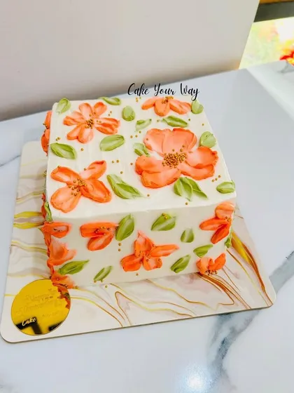 Petal perfect and oh-so-delicious. A square cake with painted buttercream flowers.