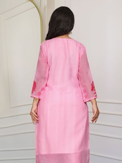 A pretty light pink organza kurta with a delicate floral print. The fabric is so light and airy, making it perfect for a summer event.
