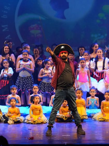 A teacher leads the charge in a pirate themed performance at our annual show. It's a perfect example of the fun, thematic productions we create with our students.