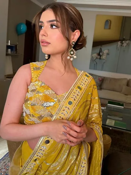 Radiating ethereal beauty with a touch of modern shimmer. This look in a yellow saree is classically inspired and flawlessly executed.