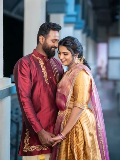 A sweet and romantic portrait of the couple, dressed in beautiful traditional attire. Their gentle embrace and happy smiles make this a heartwarming engagement photo.