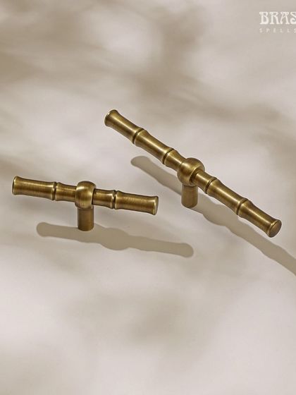 The Bamboo T-knob offers a modern and ergonomic option for cabinets and drawers. The design is both comfortable to use and visually striking, shown here in two different sizes.