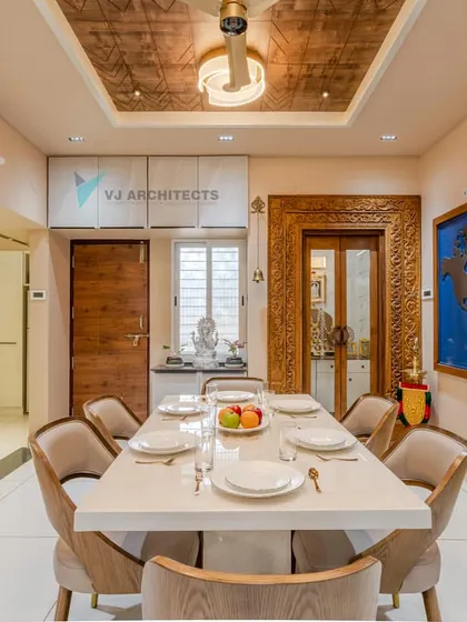 For a travel-loving couple, we designed this dining area to be the heart of their home. The custom world map art piece serves as a constant inspiration for future journeys, while the blend of traditional carved wood and modern furniture creates a space that is both worldly and deeply personal.