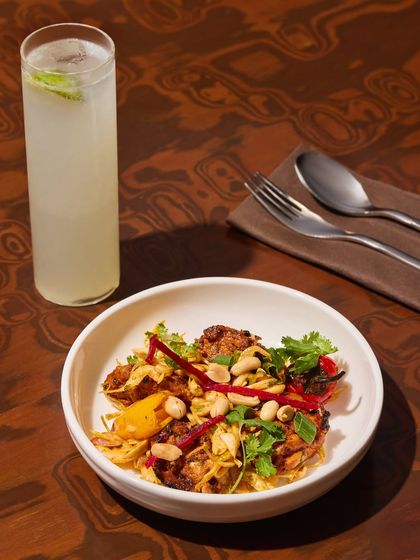 Our three-pepper chicken tikka, grilled to perfection and tossed with pickled veggies and peanuts. It packs crunch, heat, and flavour, balanced by a cool, citrusy drink.