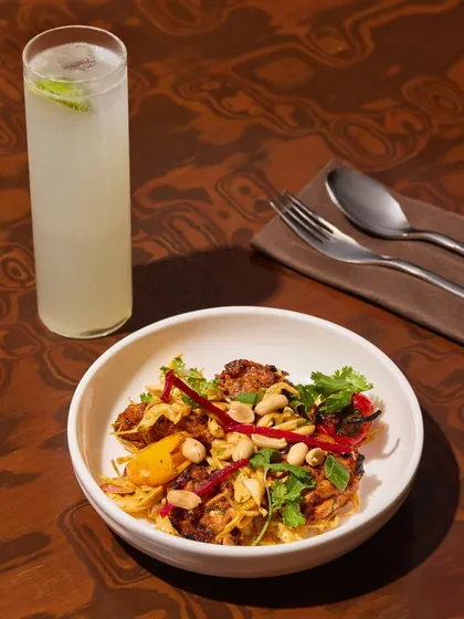 Our three-pepper chicken tikka, grilled to perfection and tossed with pickled veggies and peanuts. It packs crunch, heat, and flavour, balanced by a cool, citrusy drink.