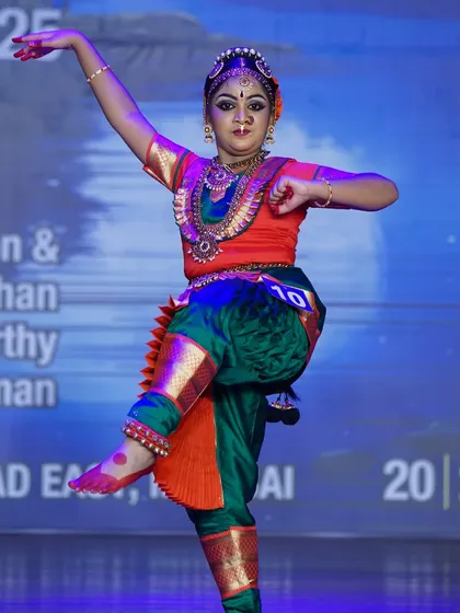 A dynamic shot of a student executing a powerful leg lift. Her energetic performance secured a 1st place win in the junior category.