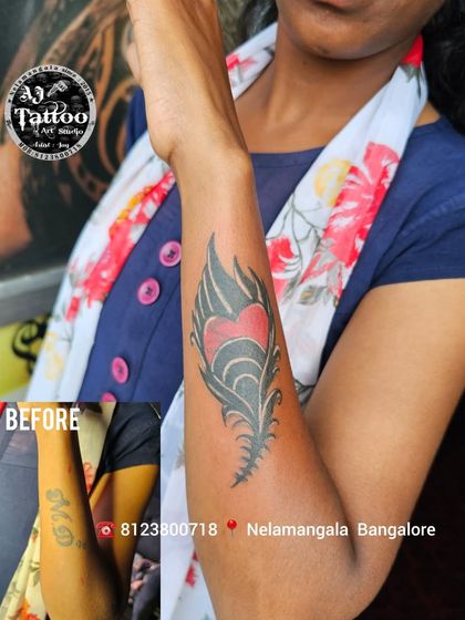 This old name tattoo is now a beautiful peacock feather with a heart. Cover-ups are a great way to reclaim your skin with new art.