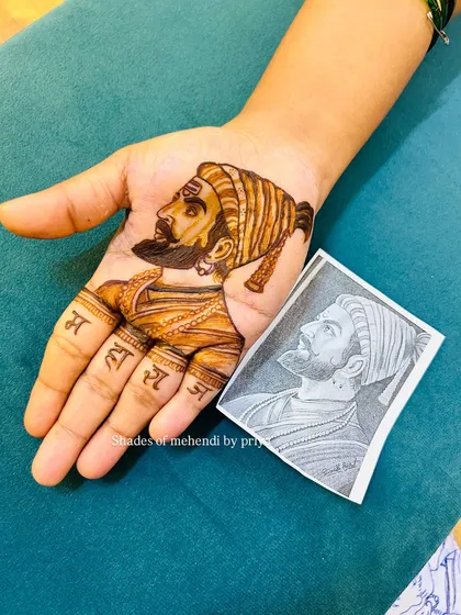 This image shows my mehendi portrait of Shivaji Maharaj next to the original reference sketch. You can see how I translate the drawing into a detailed henna design.