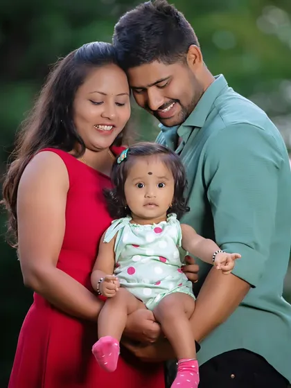 Capturing the love and connection in your growing family is what it's all about. This is a candid moment from an outdoor family portrait session, focusing on the natural interactions between parents and their child.