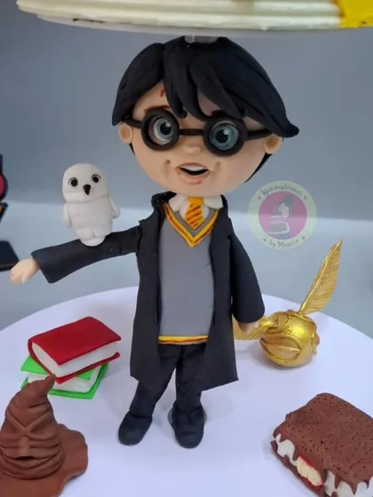 A close-up of the hand-sculpted Harry Potter figurine. Capturing the likeness and spirit of a beloved character is a skill that makes your cakes truly stand out.