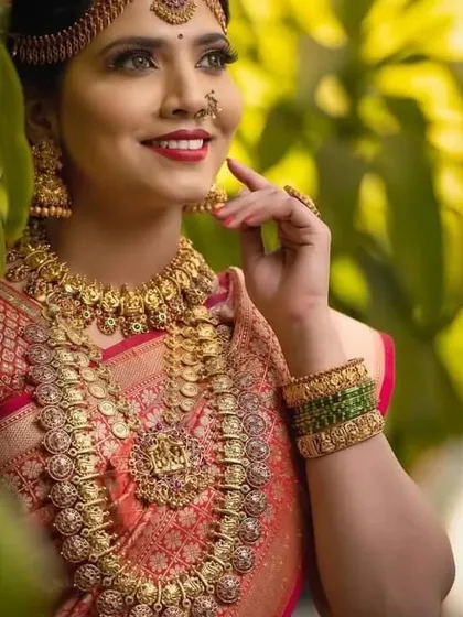 The classic Kasu Malai or coin necklace is a staple of South Indian bridal wear. This image showcases our intricately designed kasu haram paired with a matching choker and jhumkas.