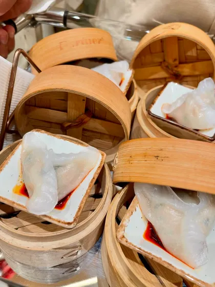 Steamed dumplings served in individual bamboo steamers, a highlight from the Tasva fashion launch event.