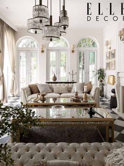 Another stunning shot from our Elle Decor feature, showcasing a living room where classic checkerboard floors meet elegant French doors and modern crystal lighting.