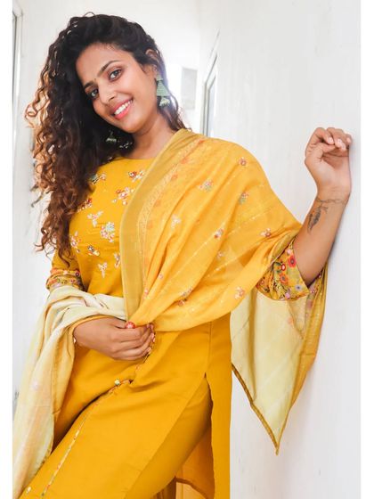 This bright yellow suit is a great example of how choosing the right color can enhance your skin tone. A simple, elegant Indian wear look for a casual day.