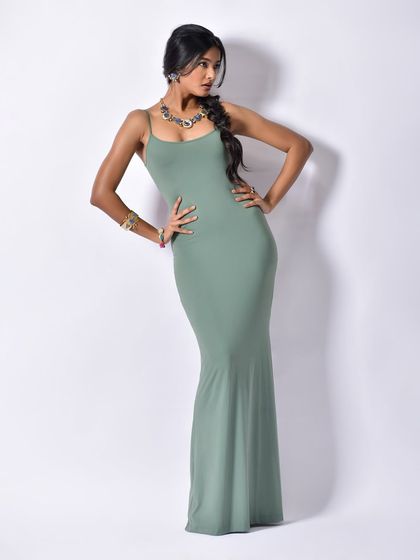 A full-length shot that displays the entire outfit and accessories. The model's strong pose conveys confidence and style.