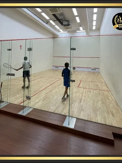 Another view of a squash training session in progress. Our courts are available for members of all skill levels to practice and improve their game.