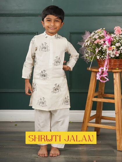 This little boy is wearing another one of my printed kurtas, this time with a subtle grey and white pattern. It’s a versatile and stylish option for any occasion.
