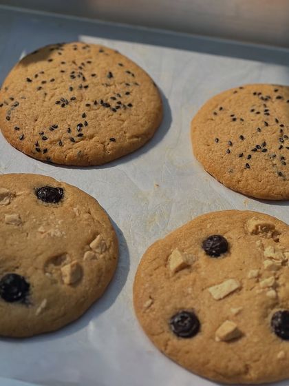 A tray of our Lemon Black Sesame and Blueberry White Chocolate cookies. We love experimenting with unique and delicious flavor combinations.