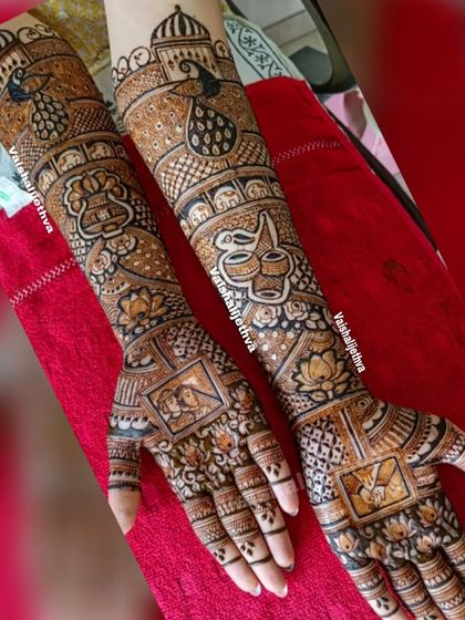 A stunning bridal design featuring a variety of wedding symbols. You can see the bride and groom portraits, kalash, peacocks, and lotus flowers, all intricately detailed.