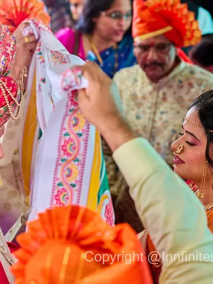 The Antarpat ritual is full of anticipation. I captured this moment just before the cloth is lowered, showing the bride and groom surrounded by family in their vibrant traditional outfits.