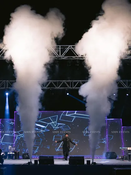 This is where performance meets production. A charismatic artist takes the stage, framed by dramatic fog effects and a custom LED backdrop. We use advanced technical production to amplify every performance, creating an immersive experience for corporate shows and celebrity nights.