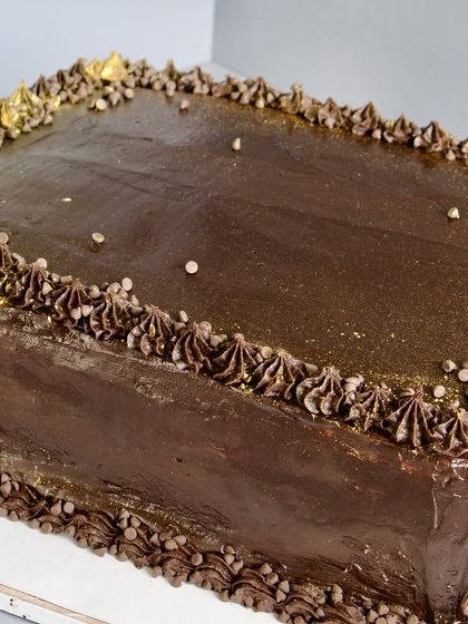 This classic corporate cake features a rich chocolate sponge layered with smooth ganache and a generous sprinkle of dark choco chips. It's simple, elegant, and irresistibly good for any office celebration.