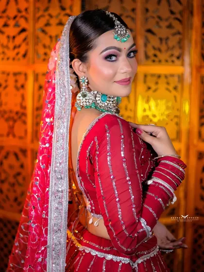 A lovely side-profile shot, highlighting the hairstyle and the elegant fall of the dupatta.