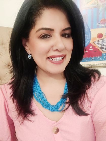 I paired the pink dress with a bold, multi-strand blue beaded necklace. This creates a fun and unexpected colour combination that really makes the outfit pop.