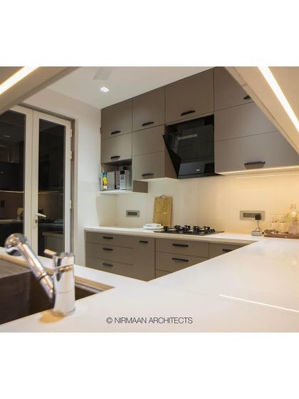 A smart kitchen at Bhagwati Greens with under-cabinet lighting and sleek, modern appliances. The design is clean, efficient, and fully integrated with the home's automation system.