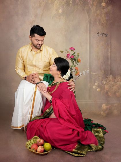 A classic couple portrait with a painterly feel. The rich colors of their traditional outfits and the soft, warm lighting create a romantic and timeless memory.