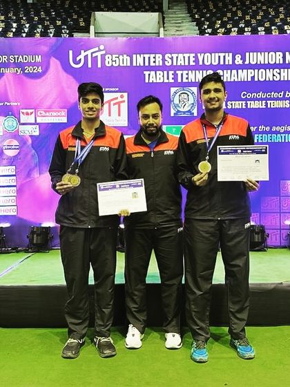 A group photo on the podium with my players Aakash K J and Rohith Shankar after their doubles bronze medal win at the nationals.