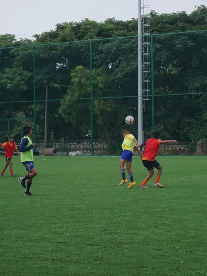 Players compete for a header in midfield. Controlling the middle of the park is crucial, and we look for players who can dominate this area.