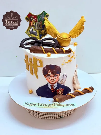 A magical Harry Potter cake for a 13th birthday. This cake features iconic elements like the golden snitch, a wand, and Harry's glasses, all crafted with great detail to delight any Potterhead.
