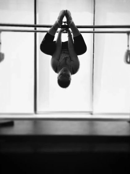 A black and white photo of a hanging pose on the Cadillac, a perfect way to find stillness and focus during the festive season.