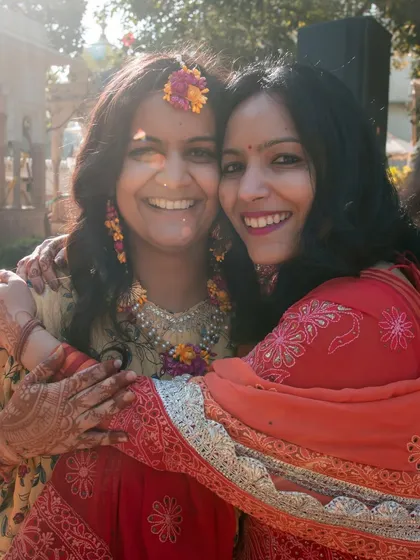 A warm hug between friends or family at the haldi ceremony, capturing the love and support surrounding the couple.