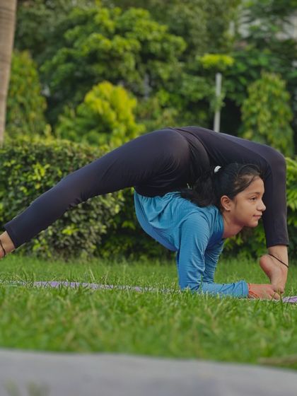 This pose is a perfect blend of strength, flexibility, balance, and endurance. Here, a young student shows a deep standing split with a backbend.