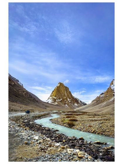 The sacred mountain of Gumbok Rangan in the Zanskar region, its golden peak standing out against the valley.