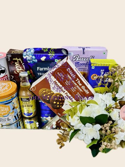 A different view of our late-night munchies hamper, showcasing the floral arrangement that adds a touch of elegance to the delicious treats.