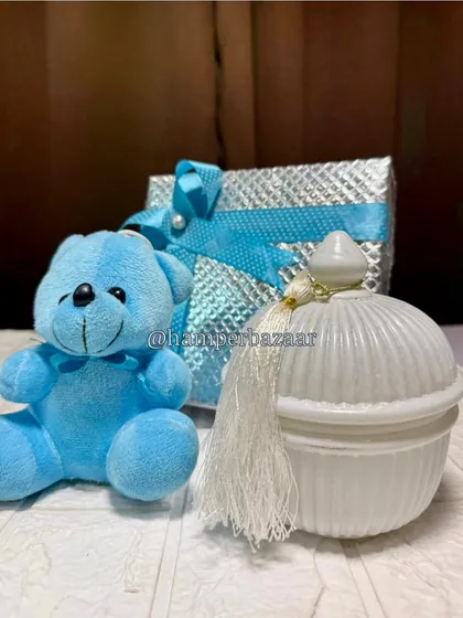 Simple and elegant. This baby boy gift set includes a blue teddy bear and a classy white decorative jar.
