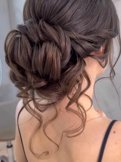 This textured, romantic updo is one of my most requested styles for receptions and cocktail parties. The interwoven sections and soft tendrils create a look that is both sophisticated and effortlessly beautiful.