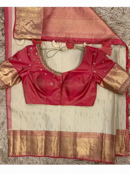 The front view of the red blouse and off-white saree combination, a timeless and classic choice for any special occasion.