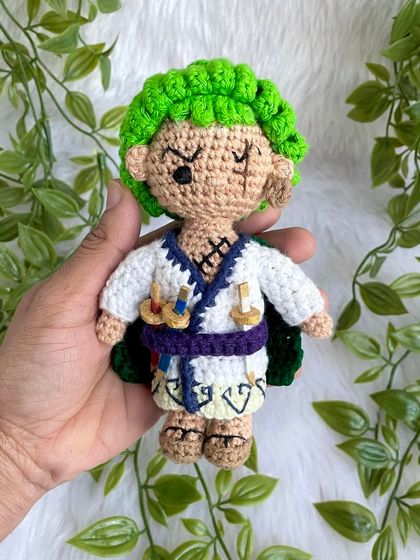 Roronoa Zoro from One Piece in a different outfit. This version features his white kimono, green cape, and of course, his three swords. It's always exciting to create new designs for a character.