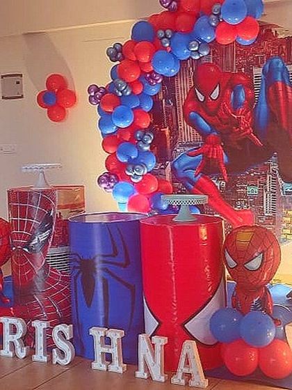 A dynamic Spiderman setup with character cutouts, themed plinths, and a city backdrop, perfect for a superhero fan.